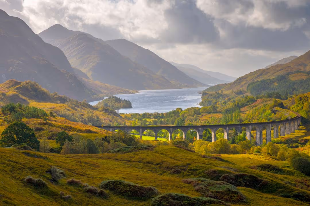 The Glenfinnan viaduct curving across the glen, with Loch Shiel running away behind it