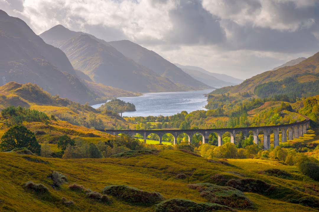 The Glenfinnan viaduct curving across the glen, with Loch Shiel running away behind it
