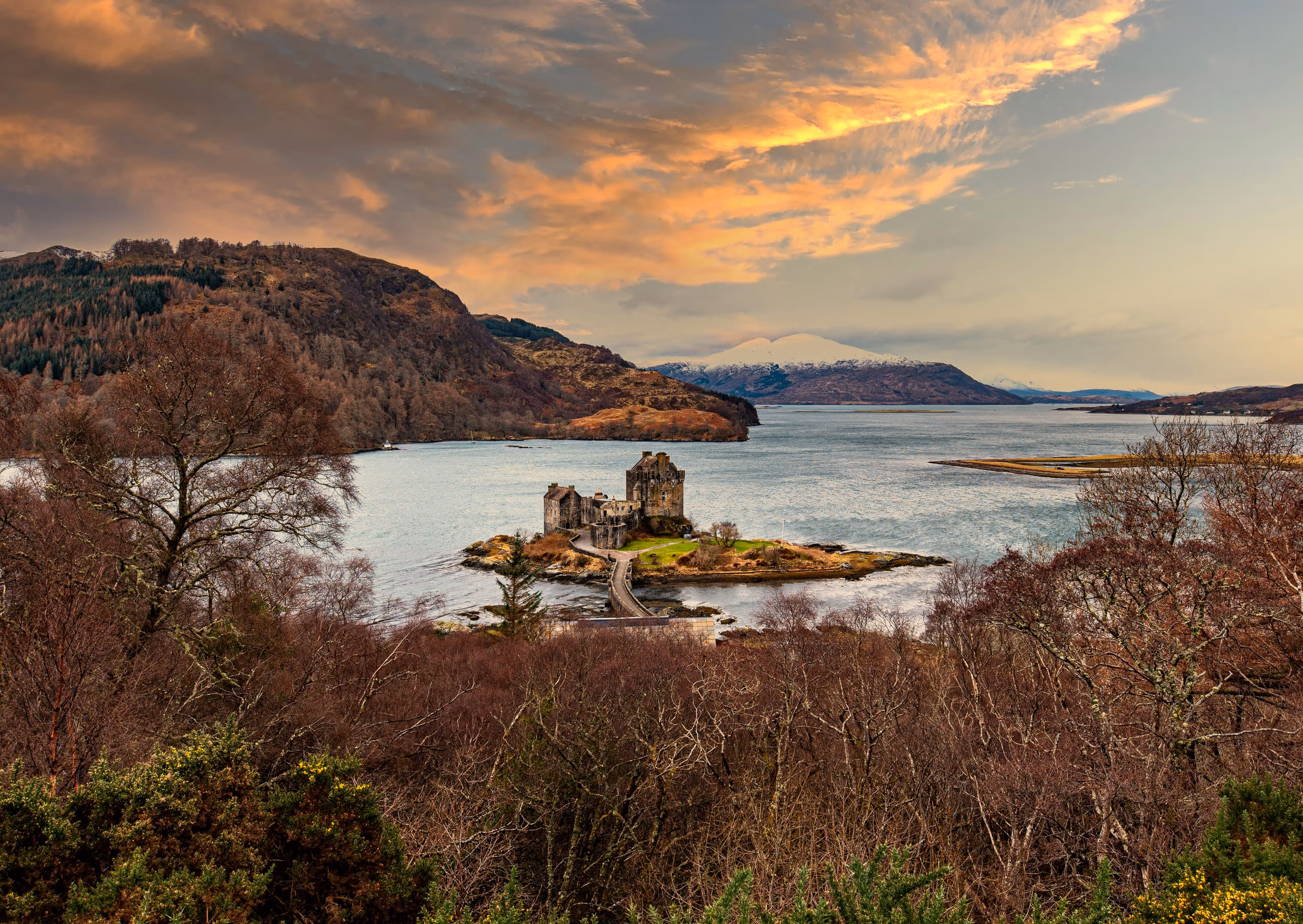 Sunset over Loch Duich from high above, Eilean Donan small on its island and snow still on the far hills